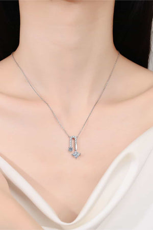 Silver geometric moissanite pendant necklace with a horseshoe shape and diamond accents.