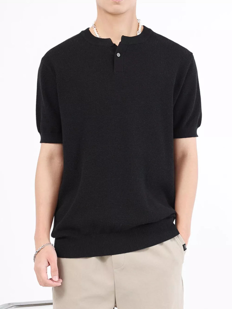 Men's black knit short sleeve henley t-shirt with button placket.