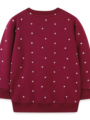 Burgundy polka dot baby sweatshirt with crew neck and ribbed cuffs and hem.