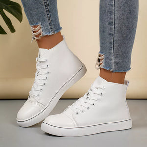 White canvas high-top sneakers with lace-up closure and contrast toe cap.