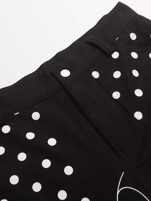Black polka dot cargo shorts with button closure and pocket details.
