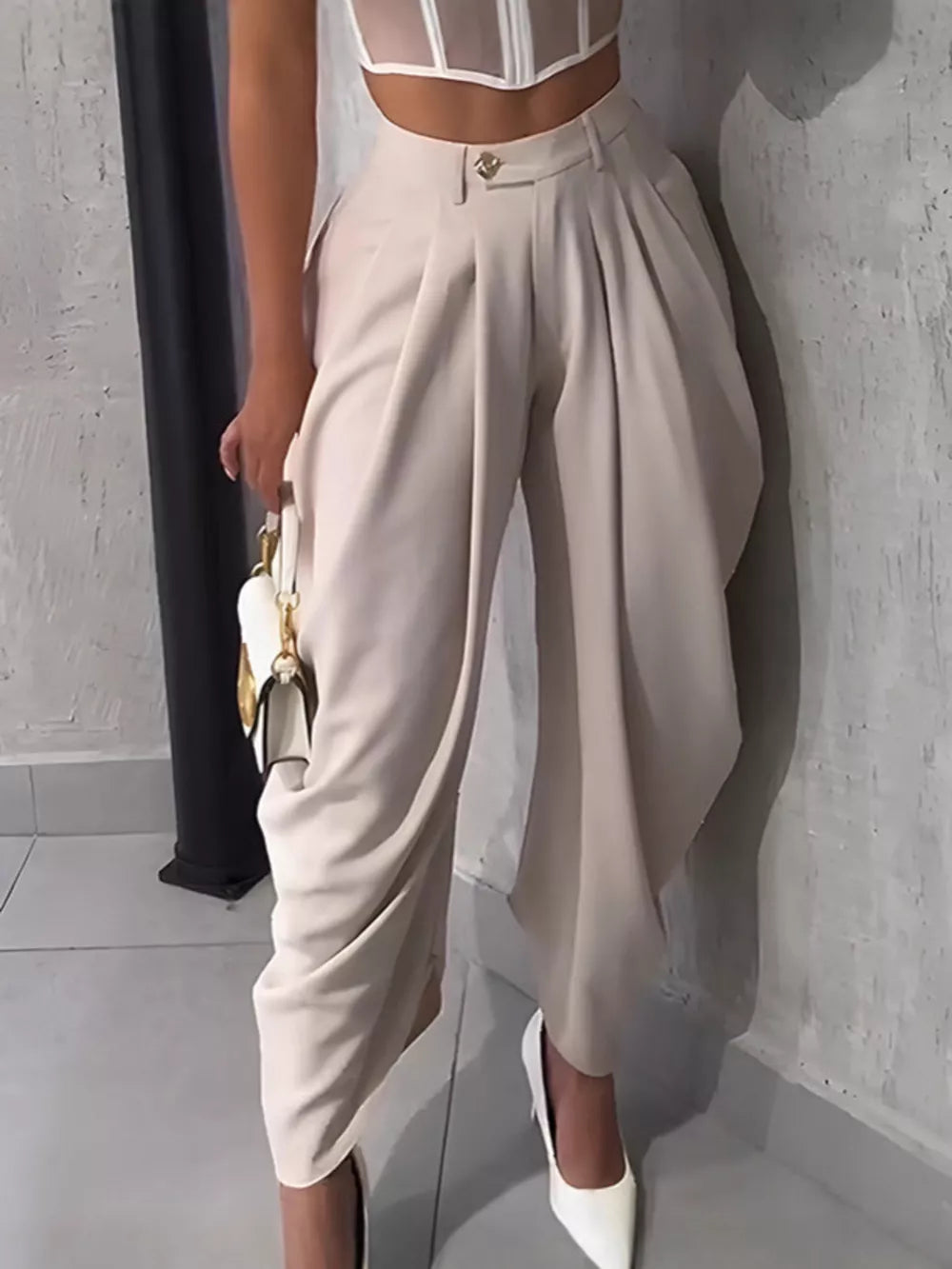 Light Khaki sculptural pleated high-waisted pants with button detail.