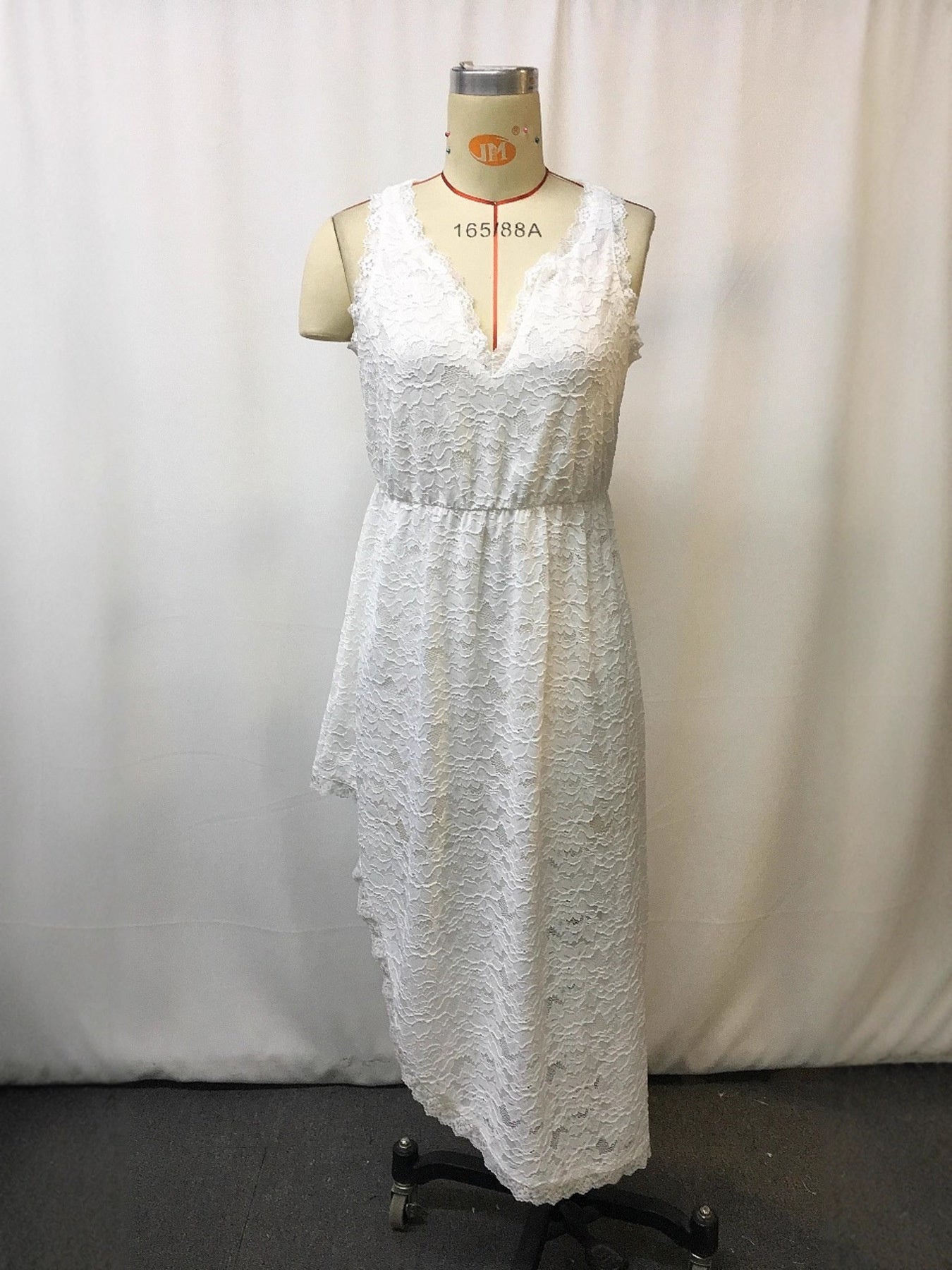White lace sleeveless dress with V-neck and asymmetrical hem