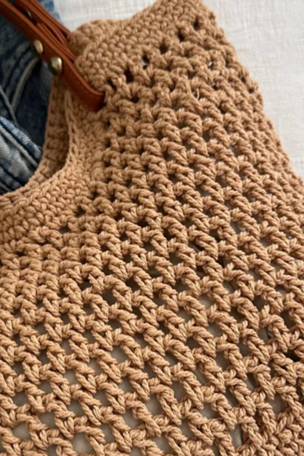 Camel crochet weave shoulder bag with leather strap detail.