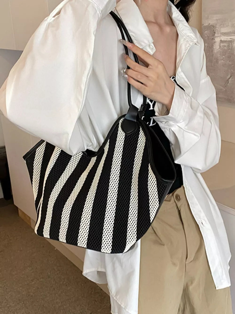 black handbag with open-front and striped