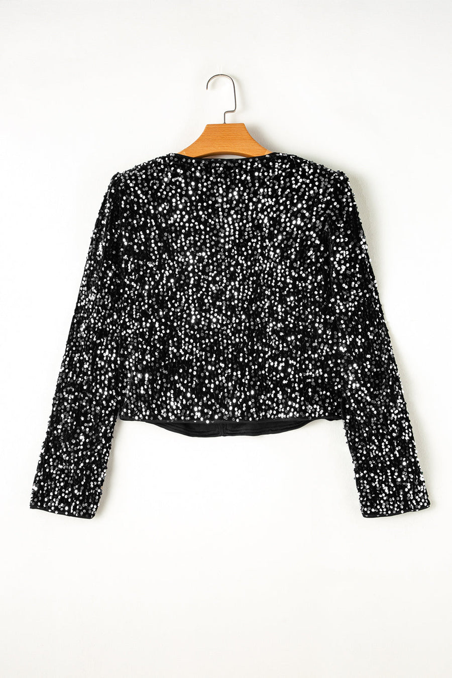 Black sequin embellished cropped open jacket with long sleeves.