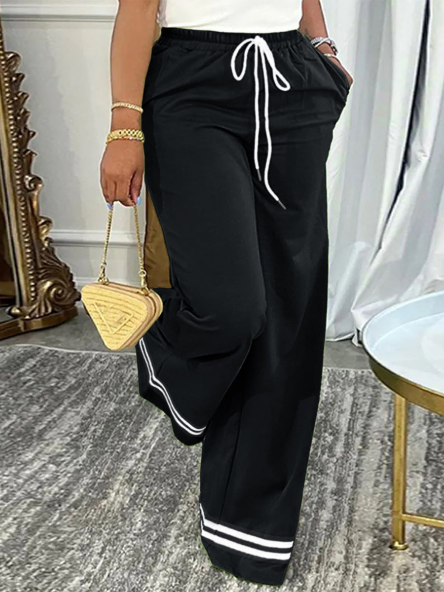 Black wide-leg pants featuring drawstring waist and striped