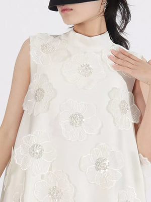 White sleeveless mock neck dress with allover floral applique and sequin detail