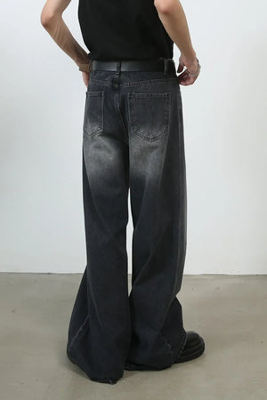 Black faded wash palazzo jeans with a wide leg and pleated detail.