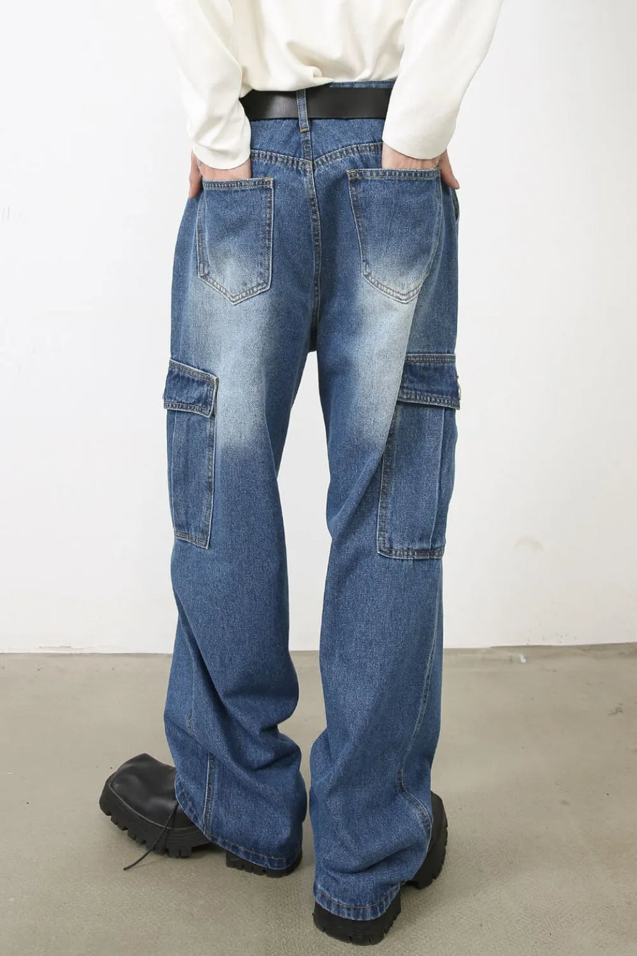 Faded denim cargo pants with multiple pockets and a relaxed fit.