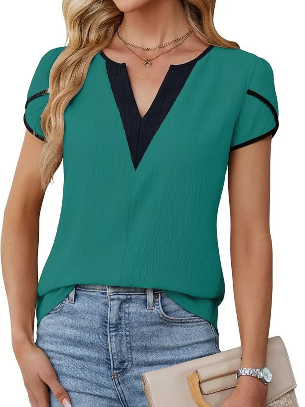 Peacock green blouse with black trim V-neck and petal sleeves.