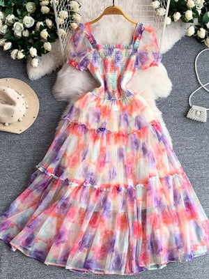 Floral tiered midi dress with smocked bodice and puff sleeves in a watercolor print.