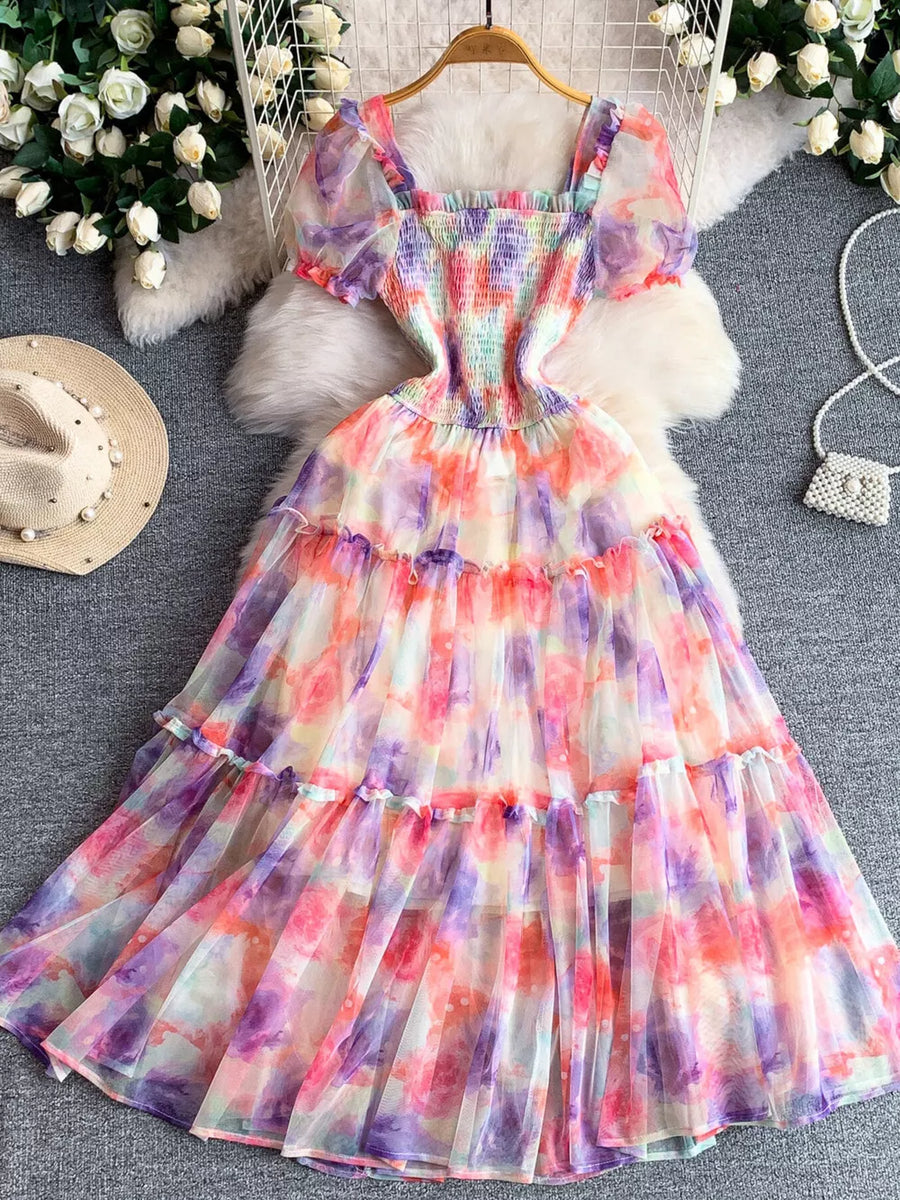 Floral tiered midi dress with smocked bodice and puff sleeves in a watercolor print.