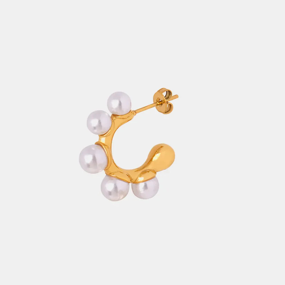 Gold hoop earrings with sculpted design and pearl accents