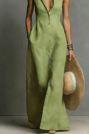 Sage sleeveless maxi dress with button front and pockets, worn by a woman holding a straw hat.