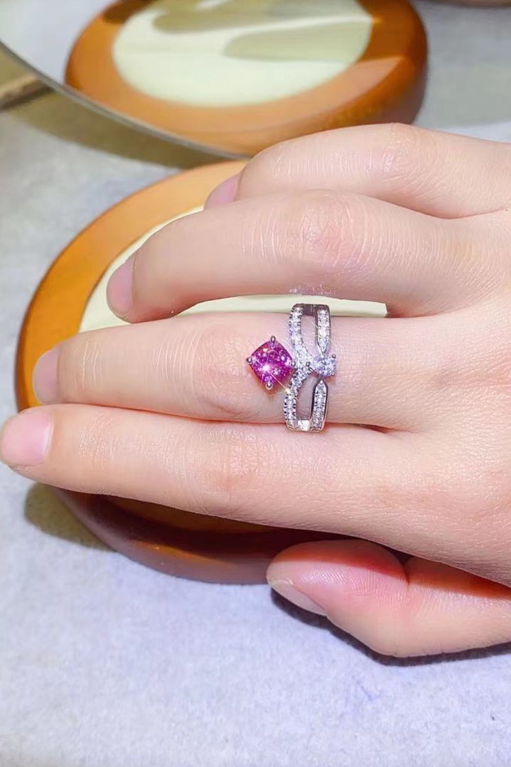 Pink moissanite bow ring with pavé detail in sterling silver.