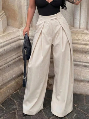 Elegant high-waisted cream wide-leg trousers with pleats and a relaxed fit.