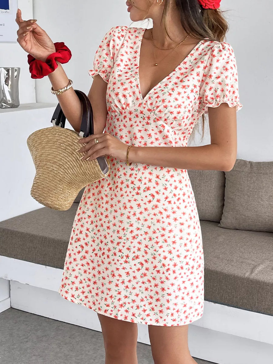Floral v-neck puff sleeve mini dress with a red floral print on a cream background.