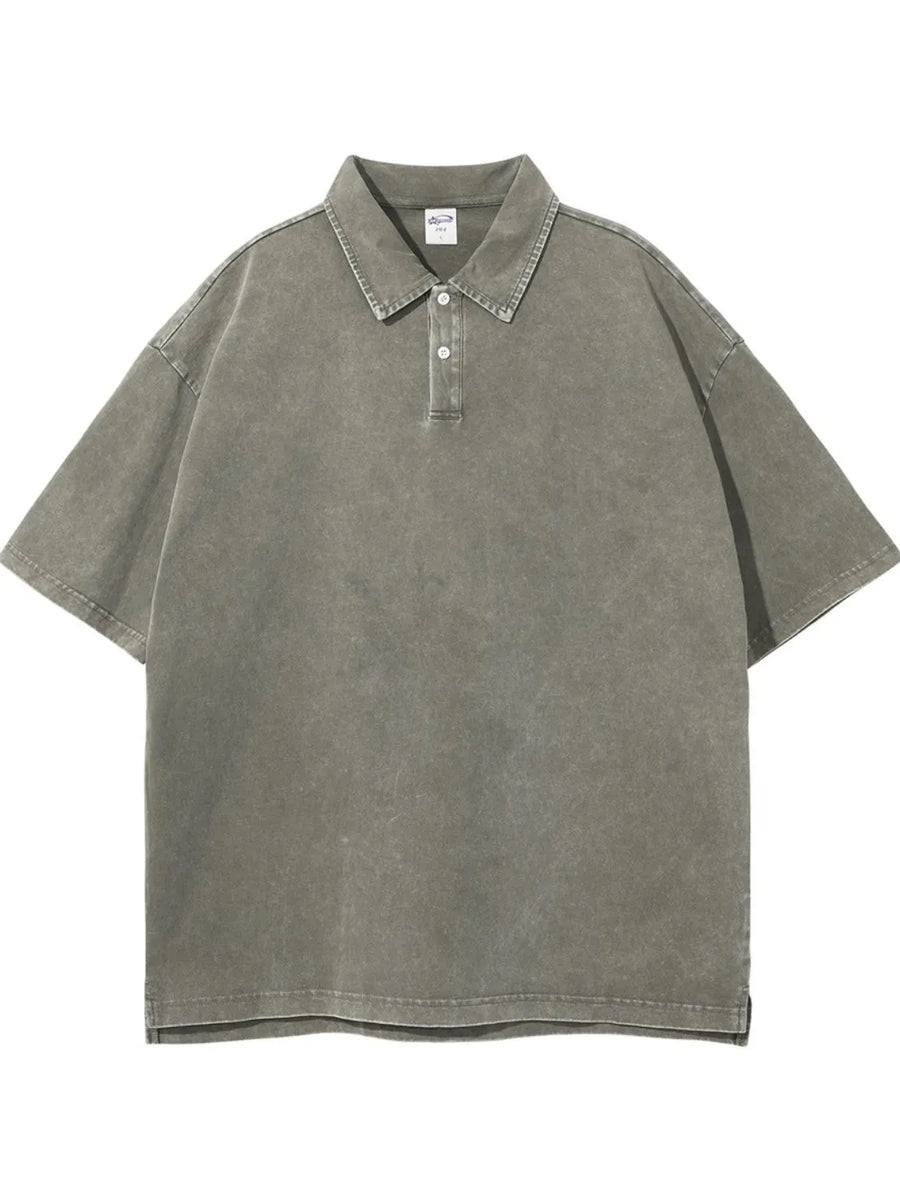 Oversized washed sage polo shirt with short sleeves and a two-button placket.