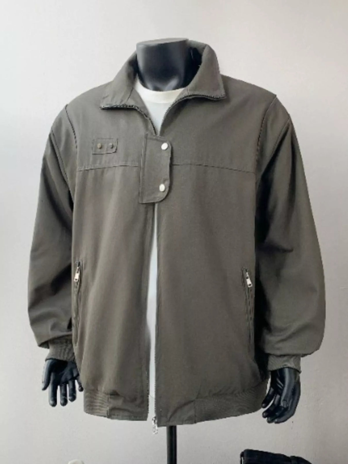 Green bomber jacket with zip pockets and buttoned flap detail