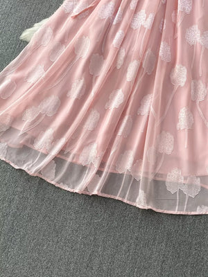 Pink chiffon maxi dress with floral embroidery and a belted waist.