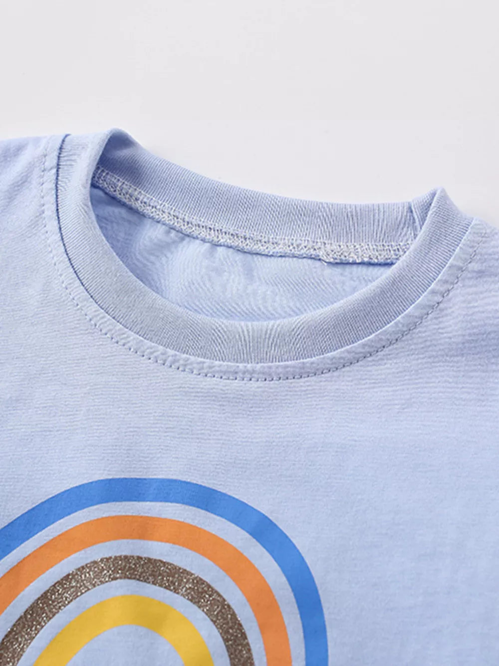 Light blue cotton blend toddler t-shirt with rainbow graphic and crew neck.