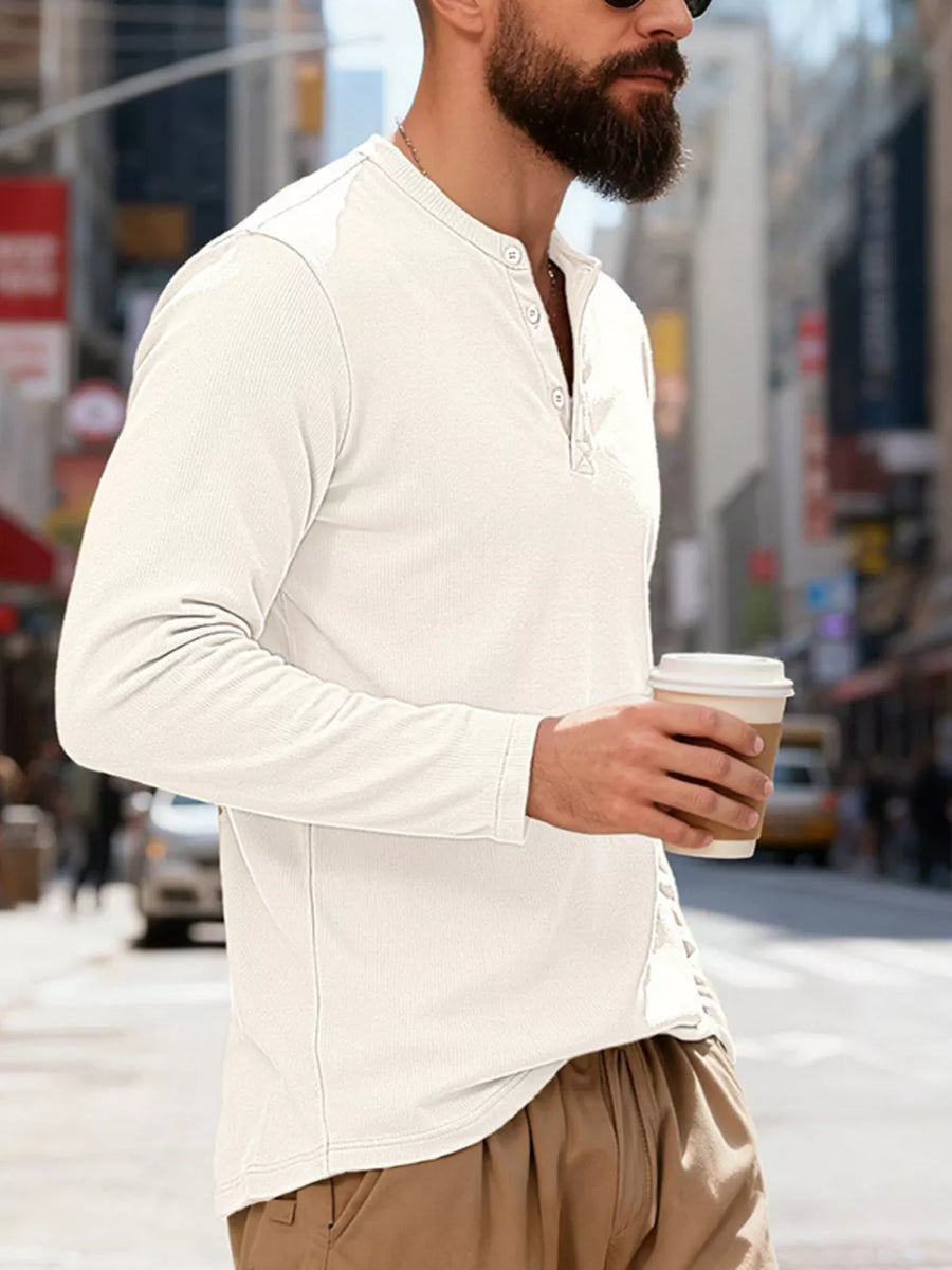 White long sleeve Henley t-shirt with button placket and ribbed texture.
