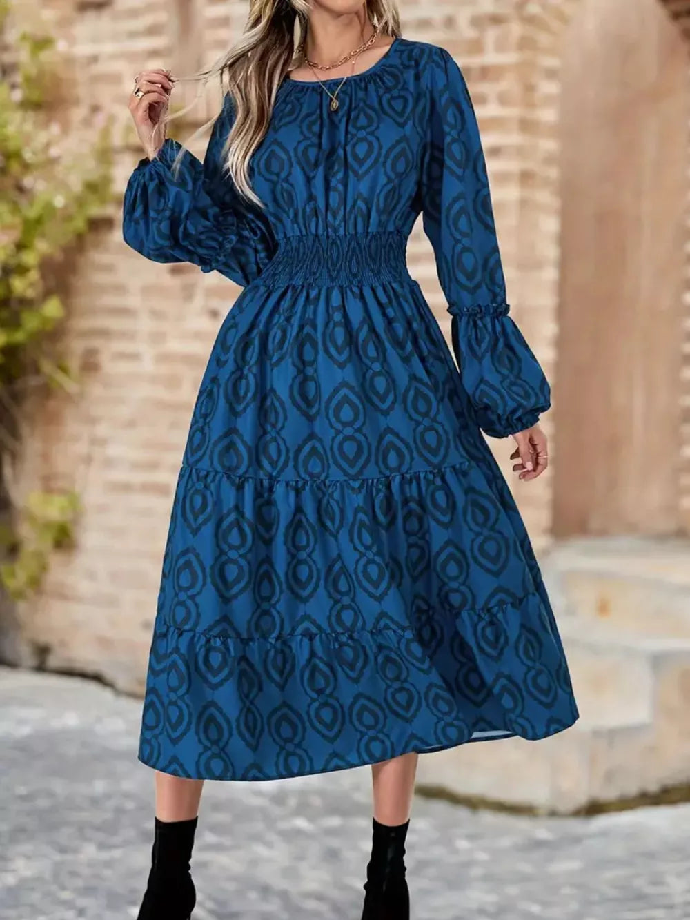 Blue abstract pattern midi dress with smocked waist and balloon sleeves.