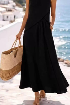 Black maxi dress with contrast detailing and pockets, sleeveless, flowing skirt.