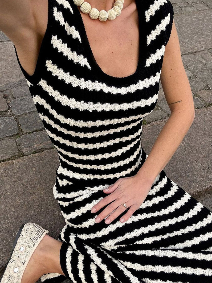 Striped knit midi dress with scoop neck and side slit, worn with a beaded necklace.