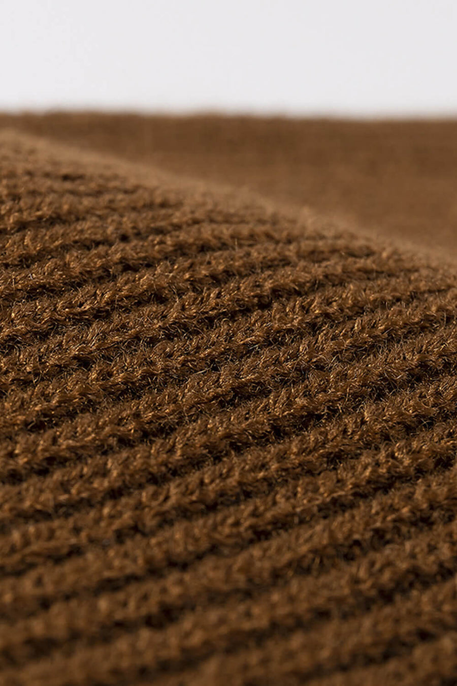 Brown ribbed knit beanie showing acrylic texture detail
