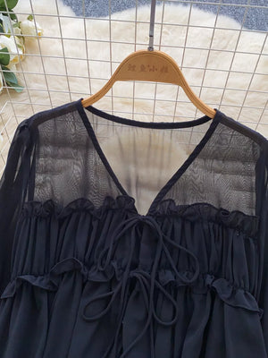 Black chiffon blouse with V-neck, tie front, and ruffled details.