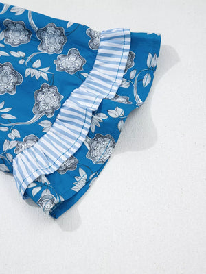 Blue cotton blouse with floral print and ruffled striped sleeves.