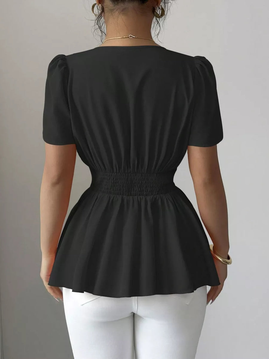 Black peplum blouse with smocked waist and puff sleeves