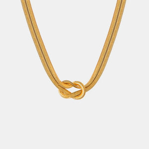 Gold serpent necklace with knot detail