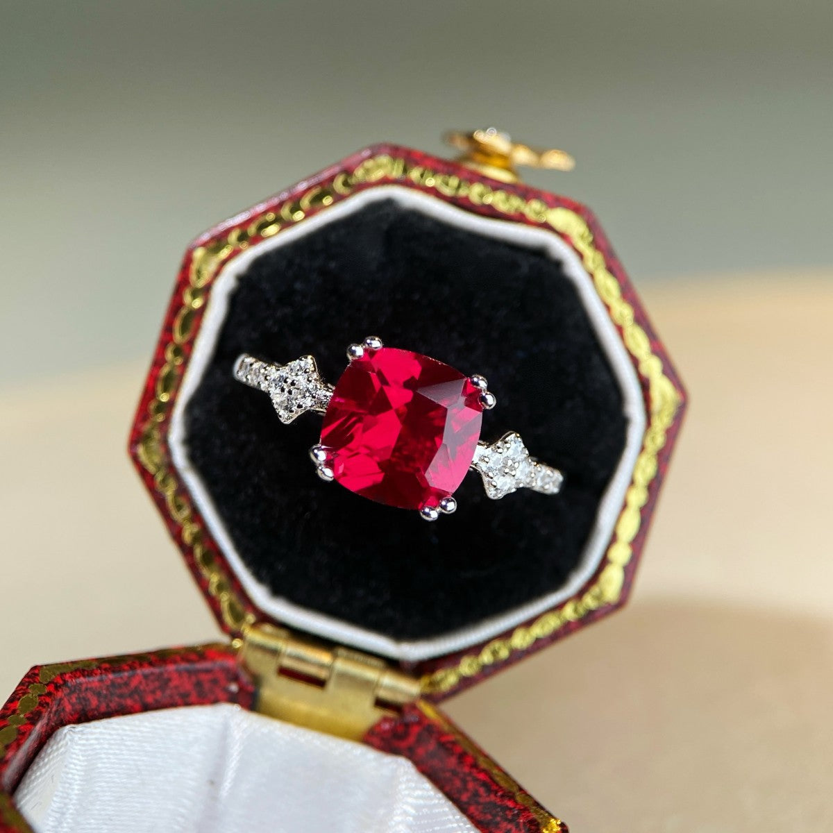 ruby red ring featuring zircon stone and geometric