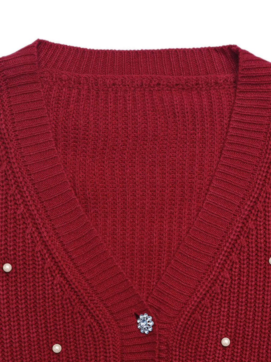 Red acrylic knit cardigan with pearl and rhinestone button details.