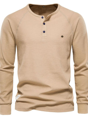 Khaki waffle knit henley top with raglan sleeves and navy buttons.