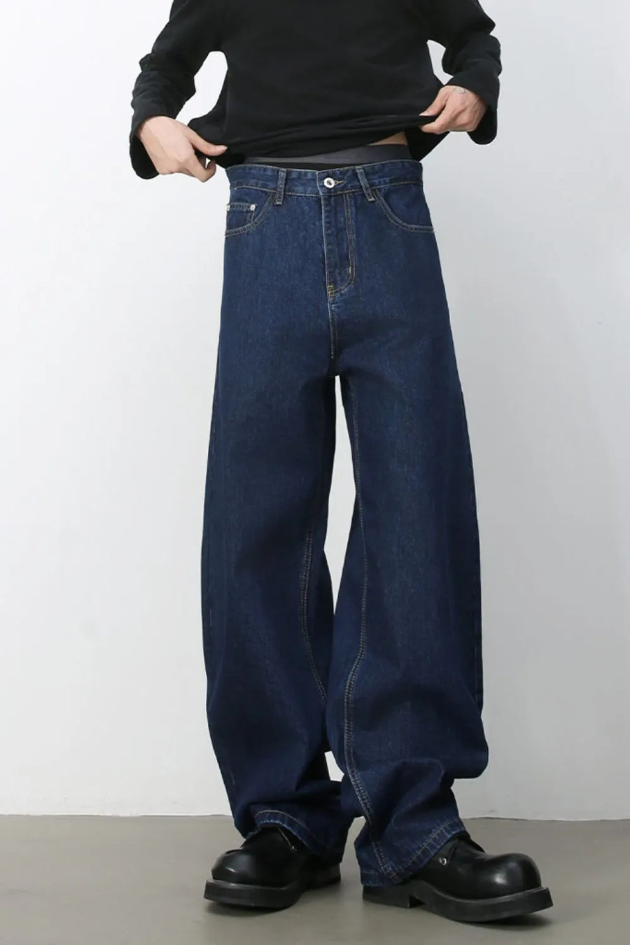 Faded baggy denim trousers in Navy, featuring a relaxed fit and casual style.