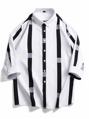 Oversized button-up shirt in white with black and grey vertical stripes and accents.