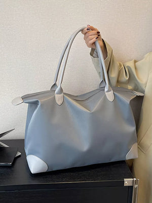 Grey Oxford cloth travel tote bag with light grey accents and double handles.