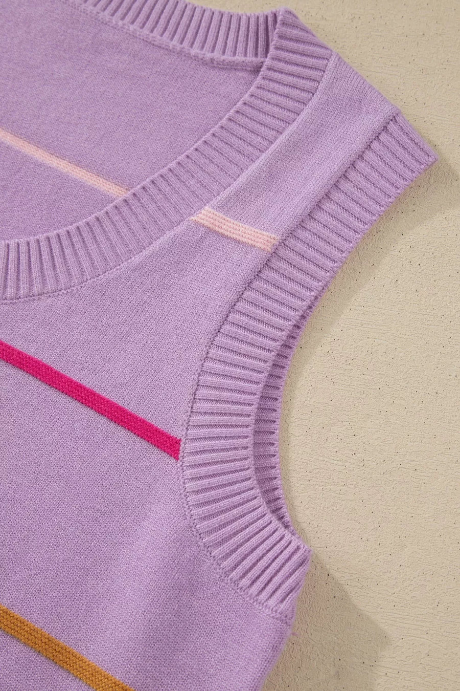 Lavender knit sweater vest with pink and brown diagonal stripes.