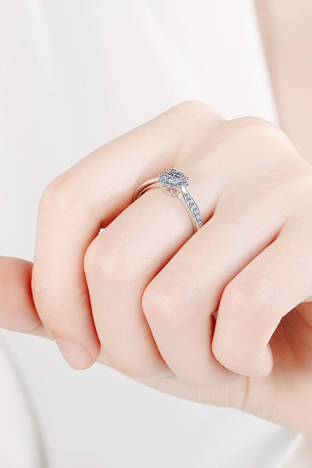 Silver moissanite ring with a celestial cluster design and pave band.