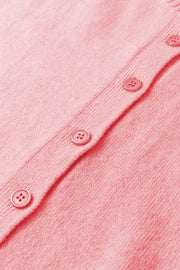Pink acrylic knit cardigan with button front detail