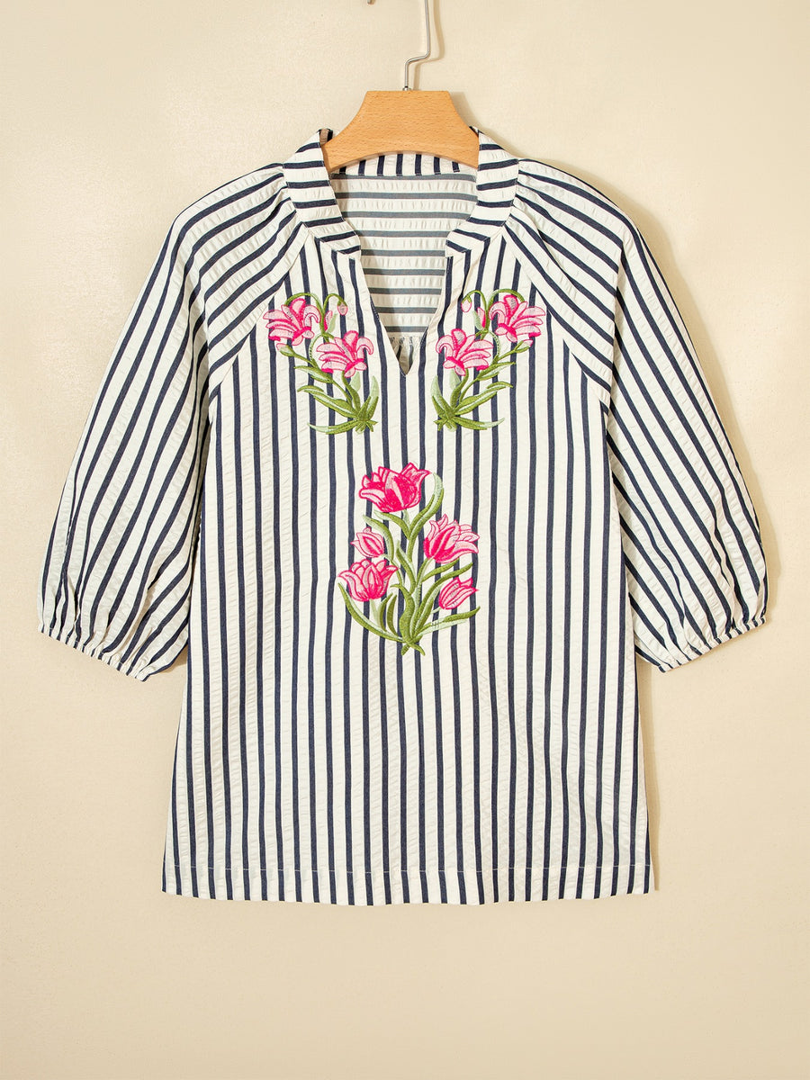 Striped V-neck blouse with pink floral embroidery and 3/4 puff sleeves.