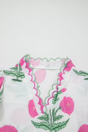 White cotton blouse with vibrant pink floral print and scalloped trim neckline.