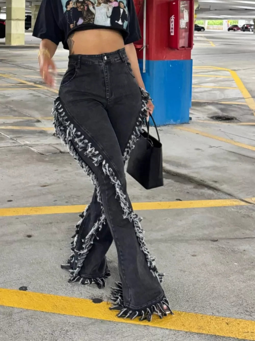 Black gray frayed hem high-waist flare jeans with deconstructed fringe detail.