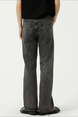 Relaxed flare denim trousers in dark gray with a washed finish and two back pockets.