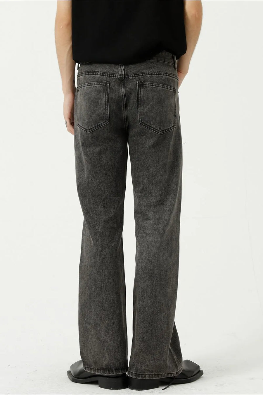 Relaxed flare denim trousers in dark gray with a washed finish and two back pockets.