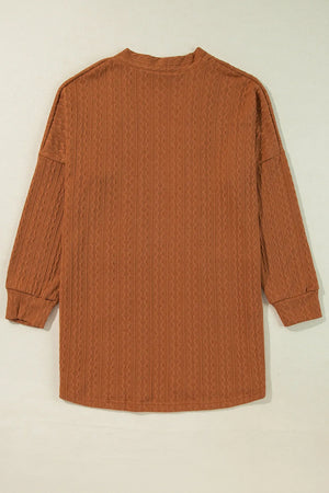 Terracotta open front cardigan with textured diamond pattern and long sleeves.